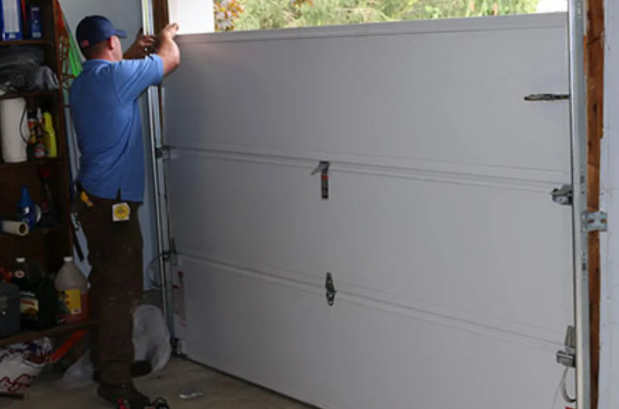 panels of garage door getting repaired