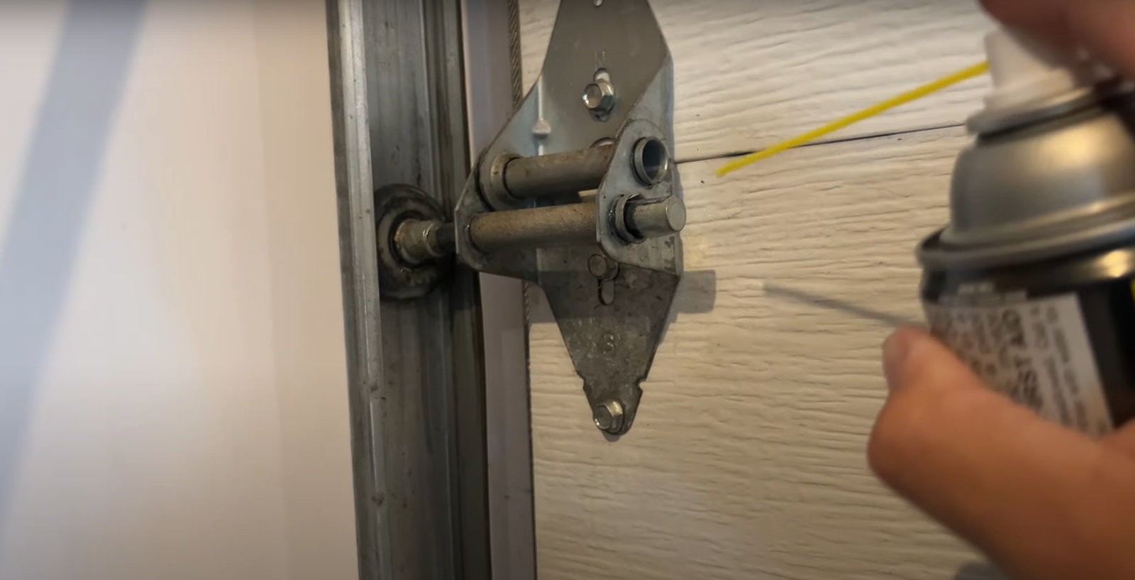 lubricating garage door hinges to fix garage door noises