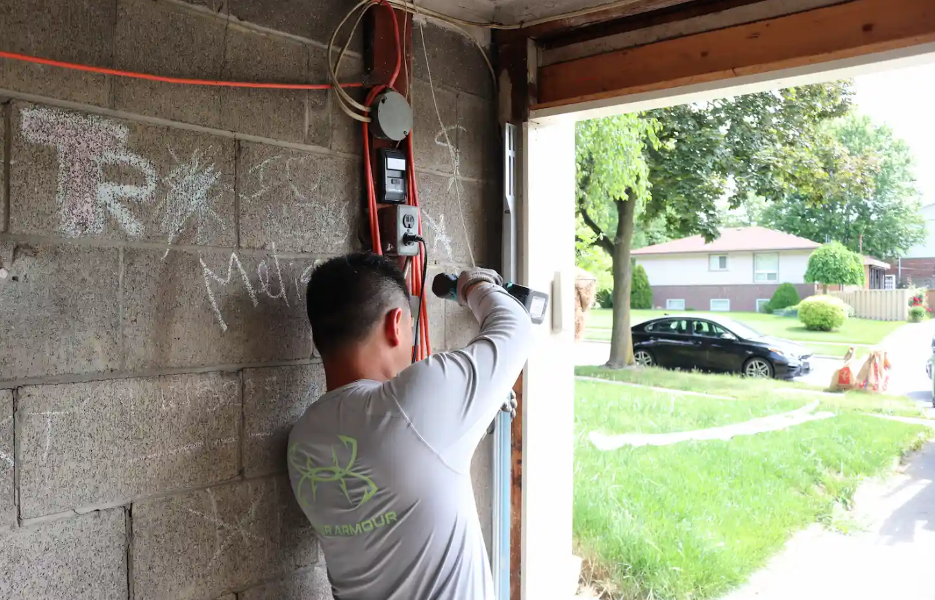 a professional performing same-day garage door repair