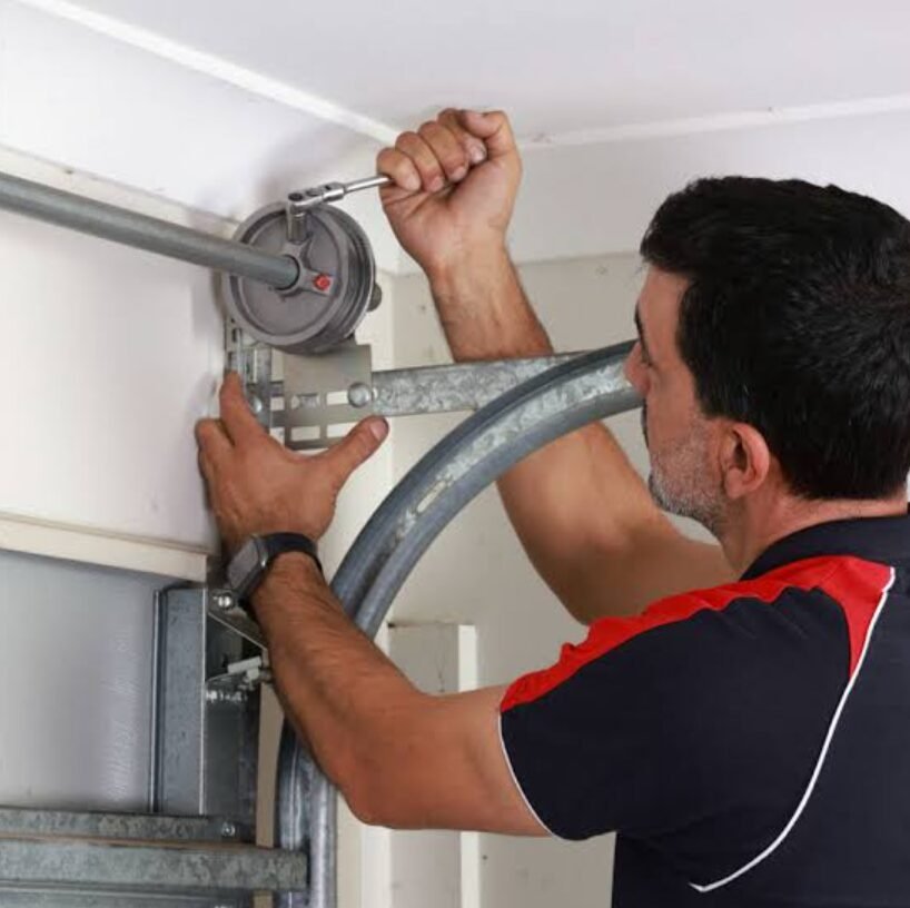 Professional Technician Repairing Garage Door System