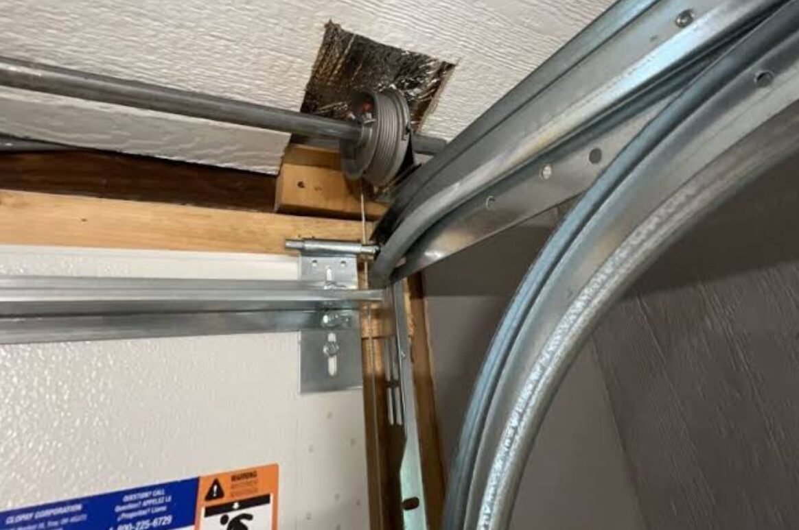 Professional Technician Fixing Jammed Garage Door in Country Club